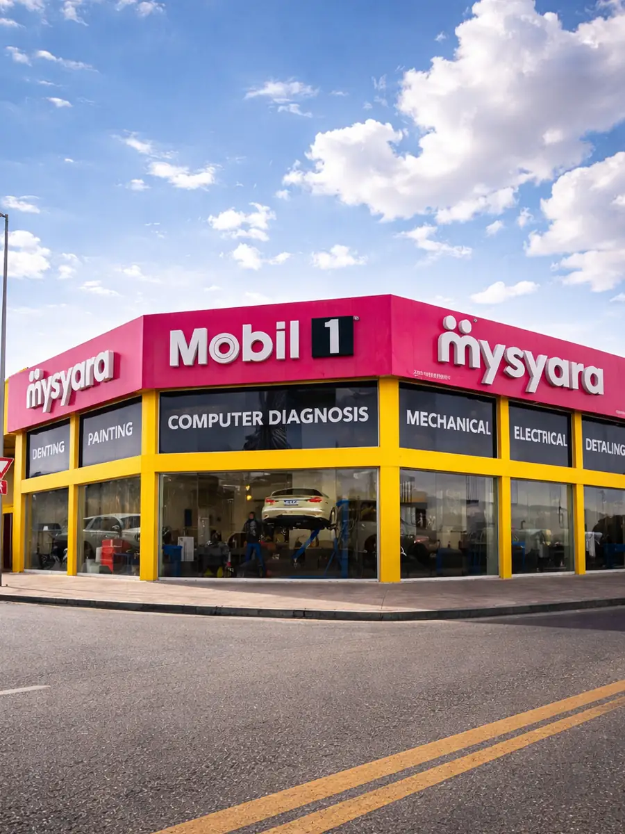A MySyara workshop branch in the UAE, Mobil 1 and mysyara signage above service bays advertising computer diagnosis, mechanical and electrical work, with a car up on a two-post lift visible through the glass frontage